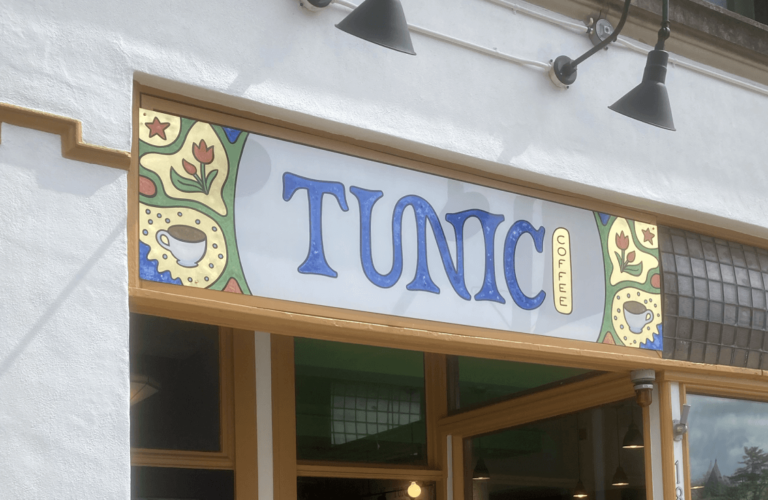 Hand-painted sign for Tunic Coffee with gold leaf